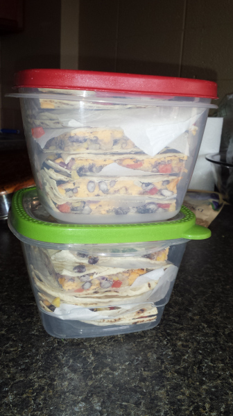 two plastic containers of quesadillas