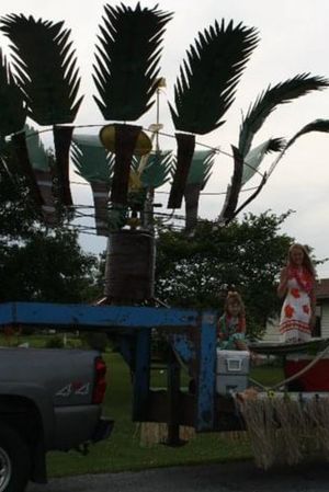 the slingshot seat thing is now inside a large palm tree statue on a float