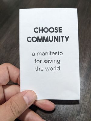 the front of a small zine on white paper, which reads 'Choose Community: a manifesto for  saving the world'