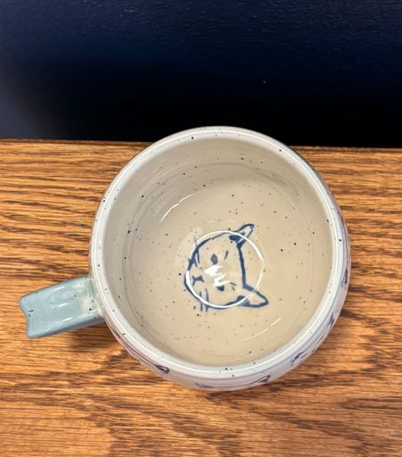 The inside of the mug in the previous image. It has a cat face printed on the bottom of the mug