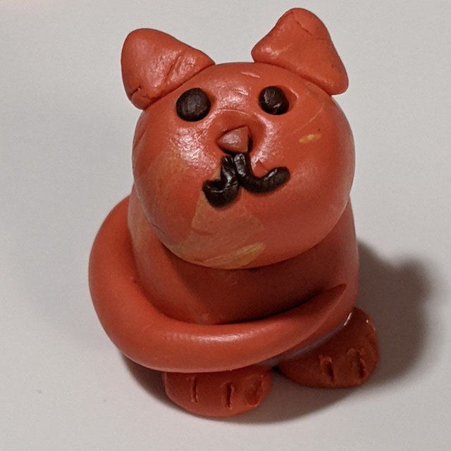 a miniature sculpture of a round orange cat