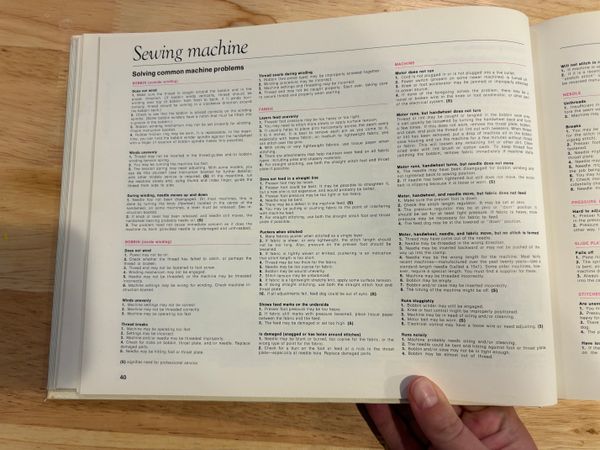 a page of the sewing book that is dense with text to help the reader troubleshoot various problems that might happen with a sewing machine